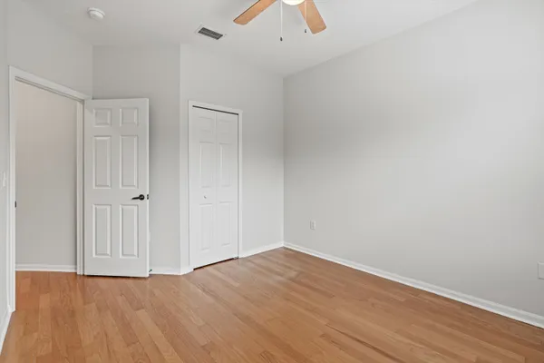 a view of an empty room with wooden floor