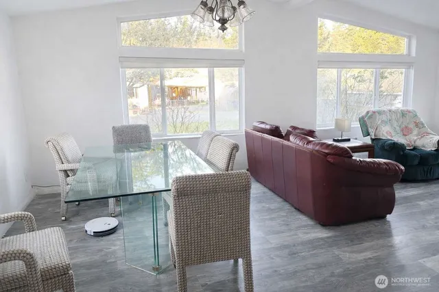 a living room with furniture and a floor to ceiling window