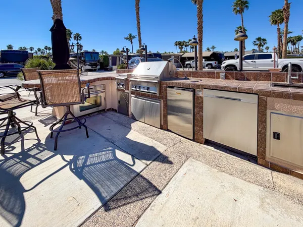 a view of a patio with couches table and chairs and potted plants