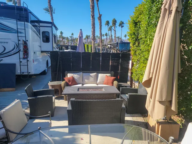 a view of a chairs and table in the balcony