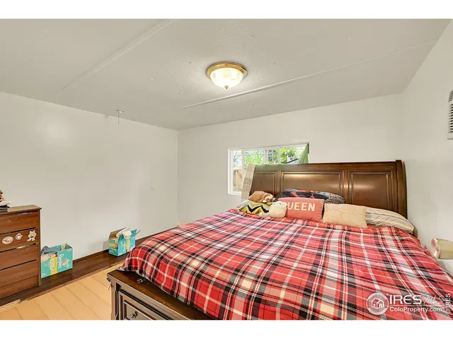 a bedroom with a bed and a lamp