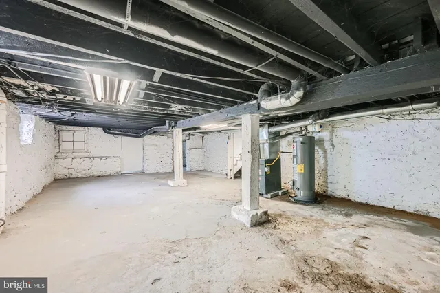 a view of a house with a small yard and large tree