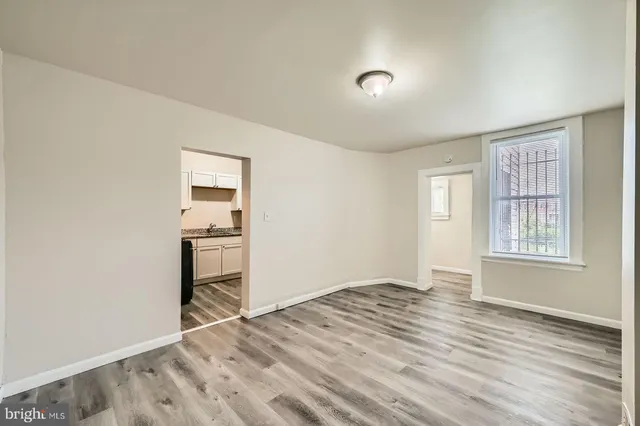 a view of an empty room with wooden floor
