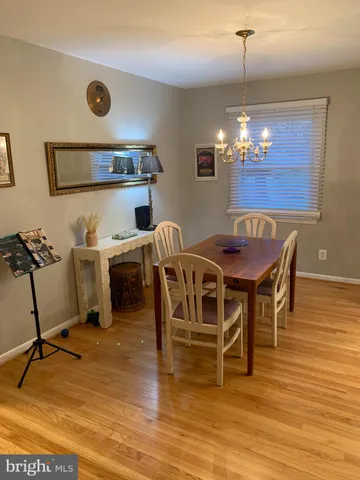 a view of a dining room with furniture and chandelier