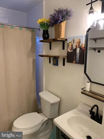 a view of a room with gym equipment and wooden floor