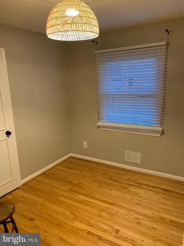 a kitchen with cabinets and chairs