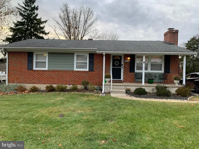a living room with furniture a rug and a window