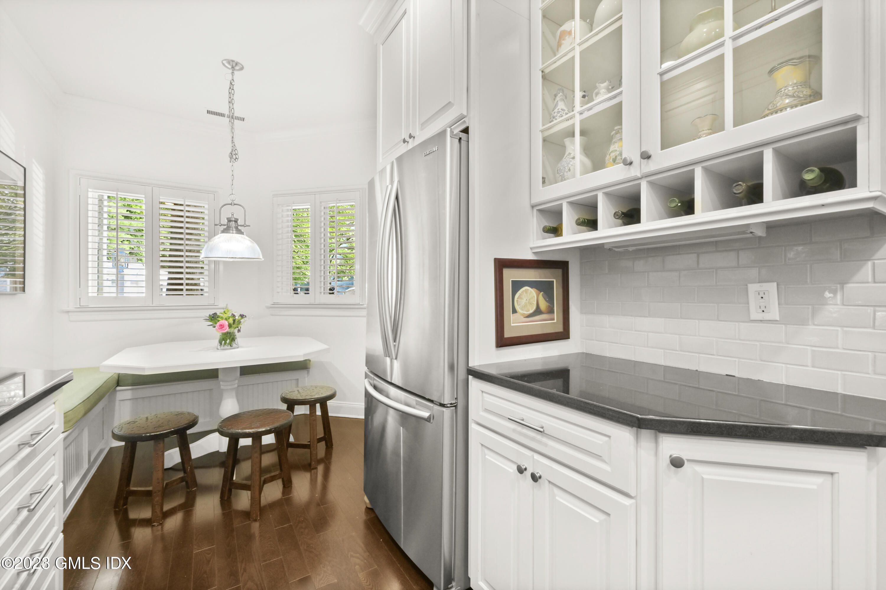 333 Palmer Hill Road, Unit 3B Riverside, CT 06878 - Photo 12 of 31 a kitchen with a dining table chairs and chandelier