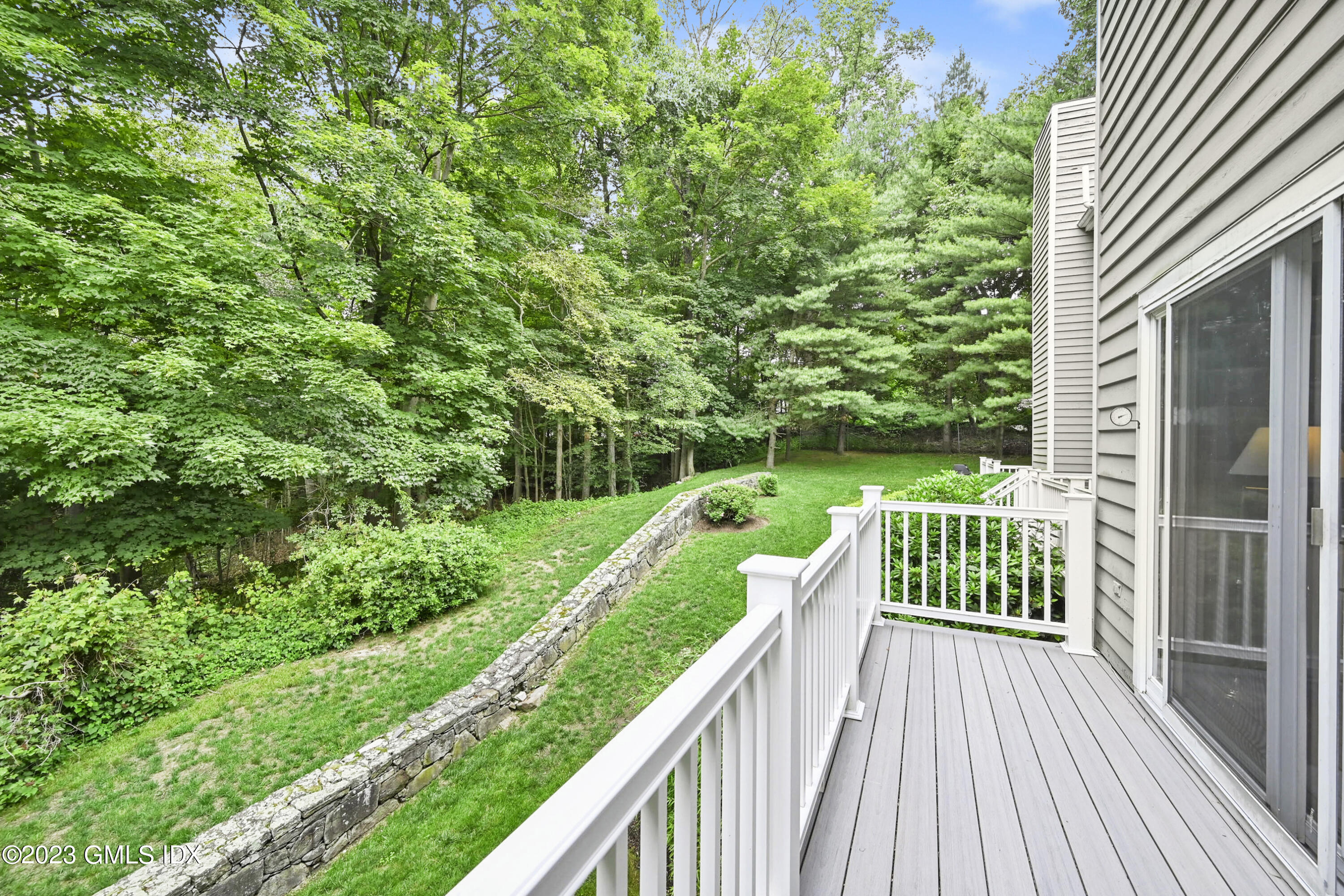 333 Palmer Hill Road, Unit 3B Riverside, CT 06878 - Photo 7 of 31 a view of backyard with a small deck and a garden