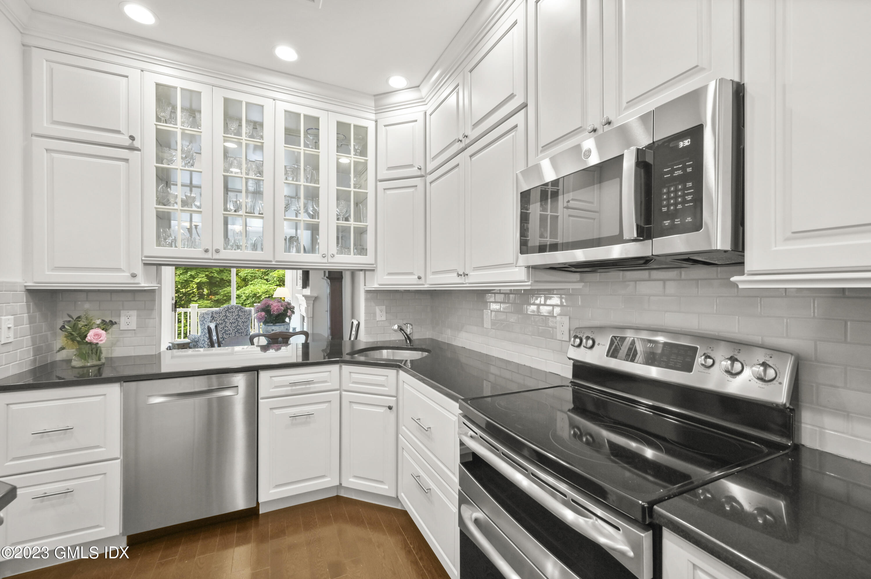 333 Palmer Hill Road, Unit 3B Riverside, CT 06878 - Photo 10 of 31 a kitchen with stainless steel appliances white cabinets and a stove top oven