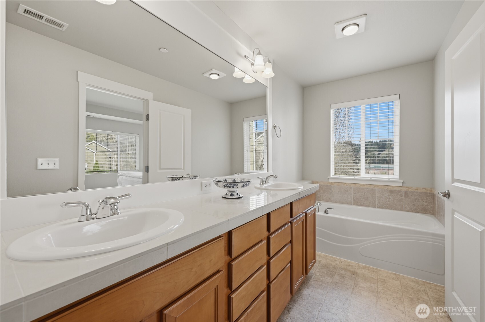 18635 101st Avenue Northeast, Unit 6 Bothell, WA 98011 - Photo 14 of 23 a bathroom with a sink double vanity granite tub and a mirror
