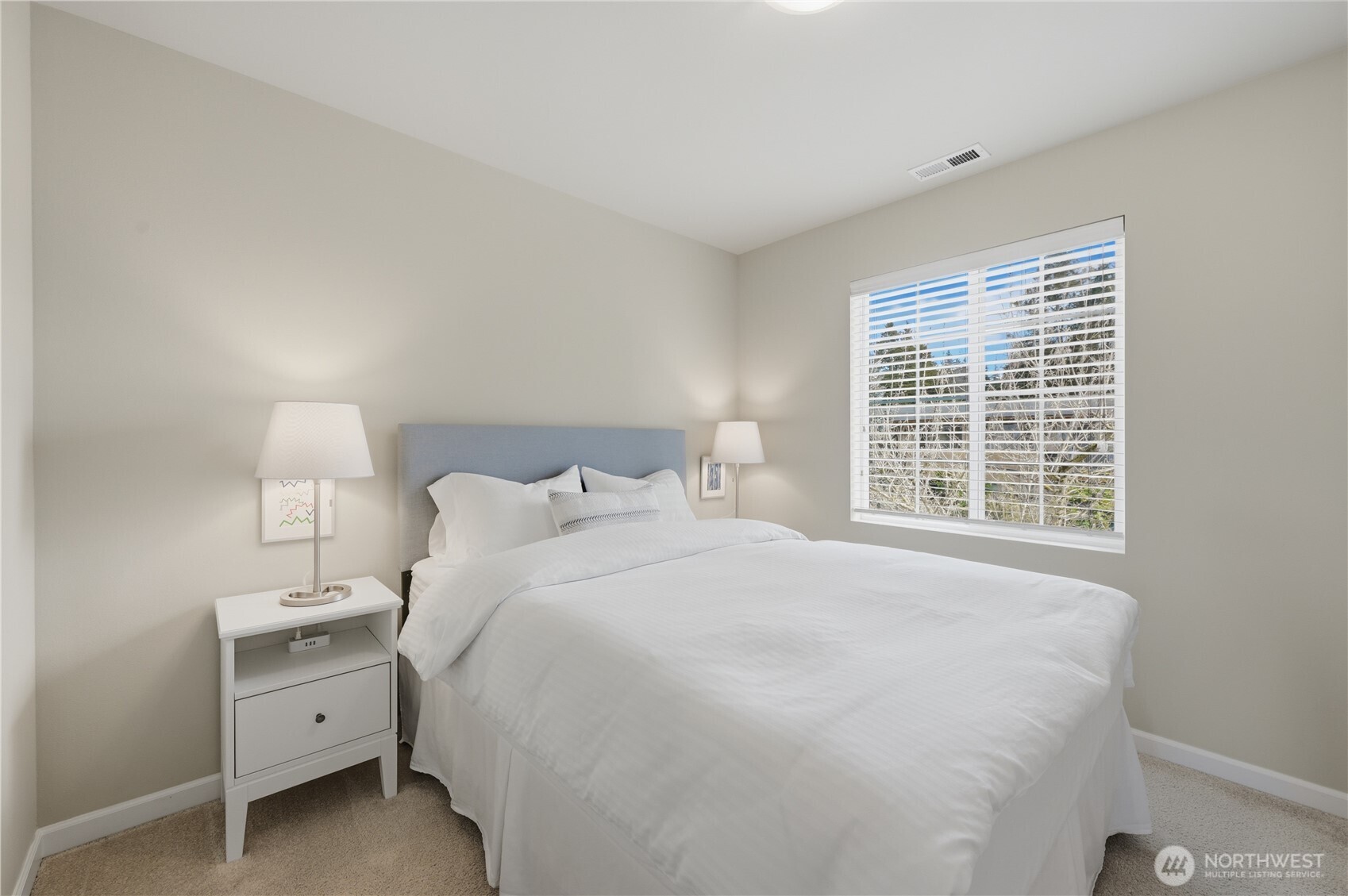 18635 101st Avenue Northeast, Unit 6 Bothell, WA 98011 - Photo 16 of 23 a large bed sitting in a bedroom next to a window