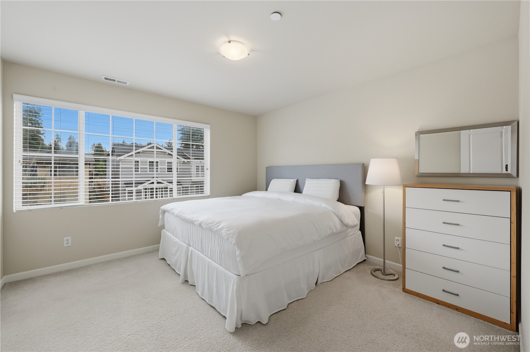 18635 101st Avenue Northeast, Unit 6 Bothell, WA 98011 - Photo 18 of 23 a bedroom with a bed and a window