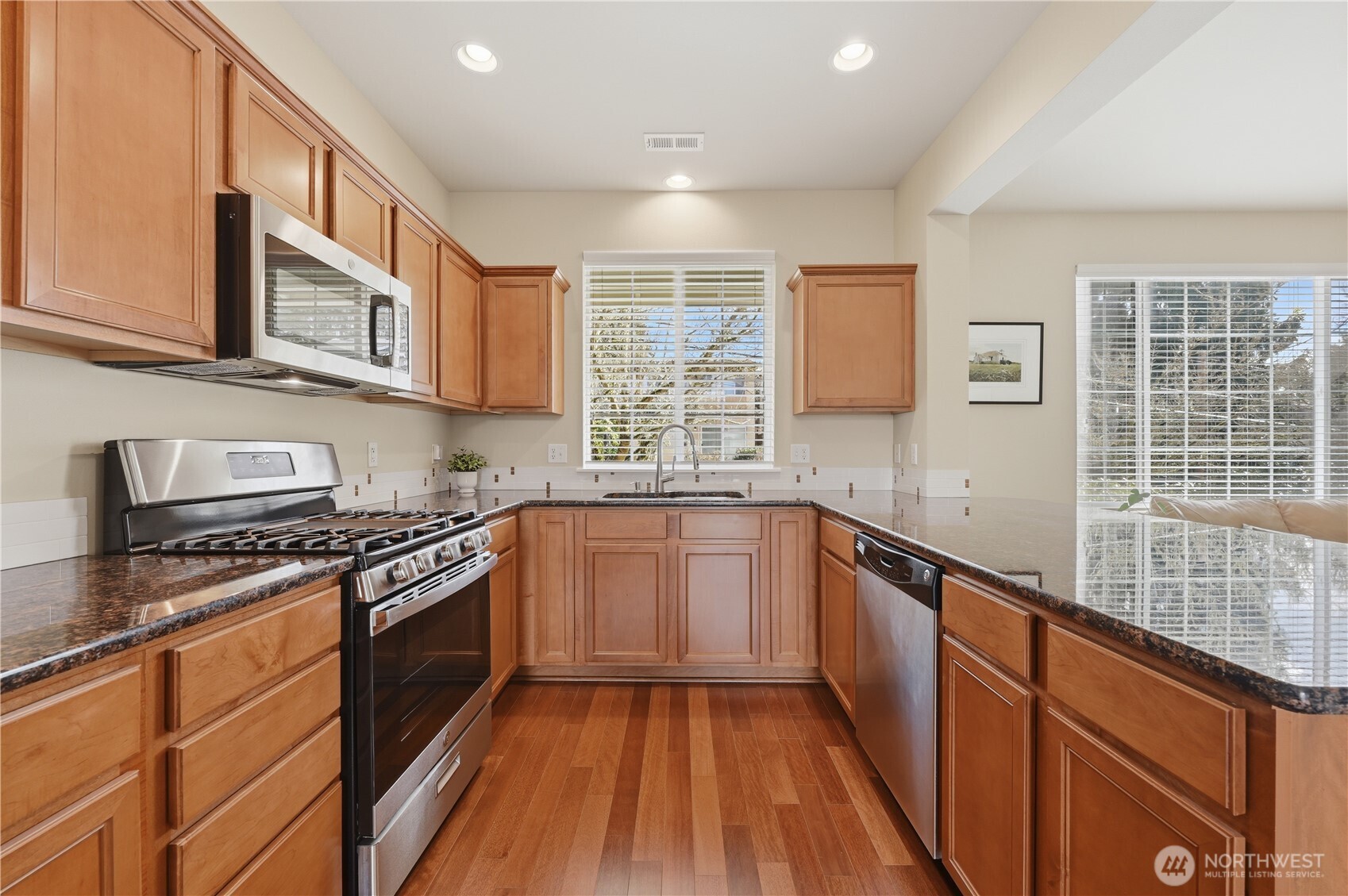 18635 101st Avenue Northeast, Unit 6 Bothell, WA 98011 - Photo 6 of 23 a kitchen with stainless steel appliances granite countertop a stove and a sink