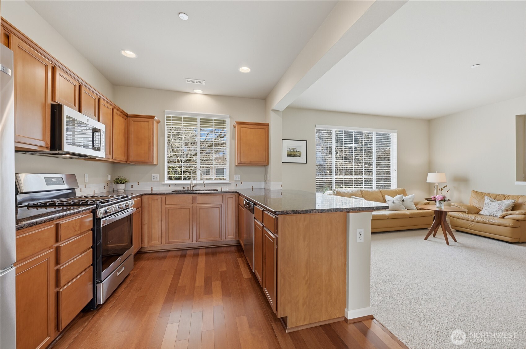 18635 101st Avenue Northeast, Unit 6 Bothell, WA 98011 - Photo 8 of 23 a kitchen with stainless steel appliances granite countertop a stove and a sink