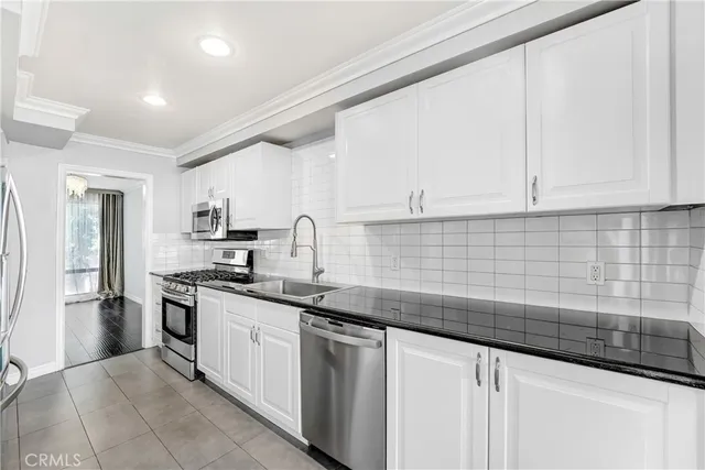 a kitchen with stainless steel appliances granite countertop a sink stove and cabinets