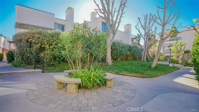 a view of a patio with table and chairs and potted plants
