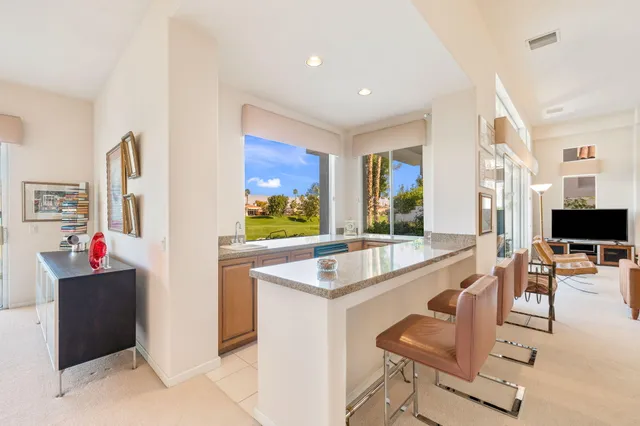 a view of a livingroom with workspace and a window