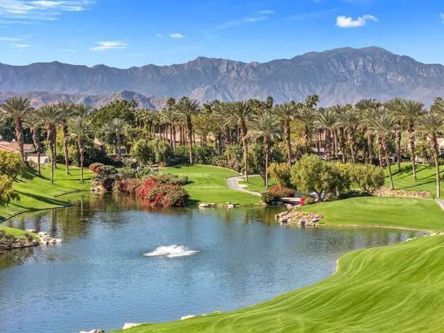 a view of a house with a yard and lake view