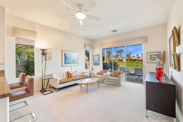 a view of a patio with table and chairs and potted plants