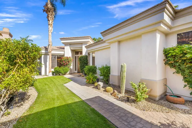 a living room with furniture and a view of kitchen