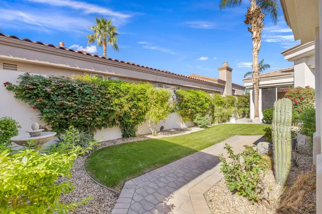 a living room with furniture and a painting on the wall