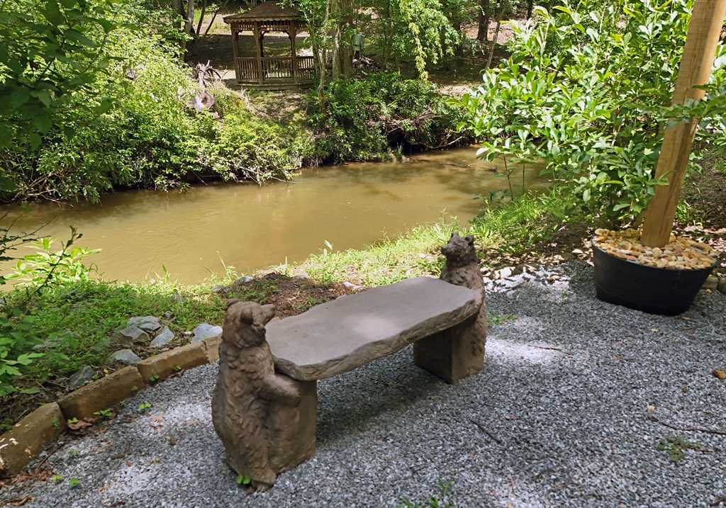 789 Old Mill Pond Road Mineral Bluff, GA 30559 - Photo 19 of 59 a wooden bench sitting in the middle of a garden