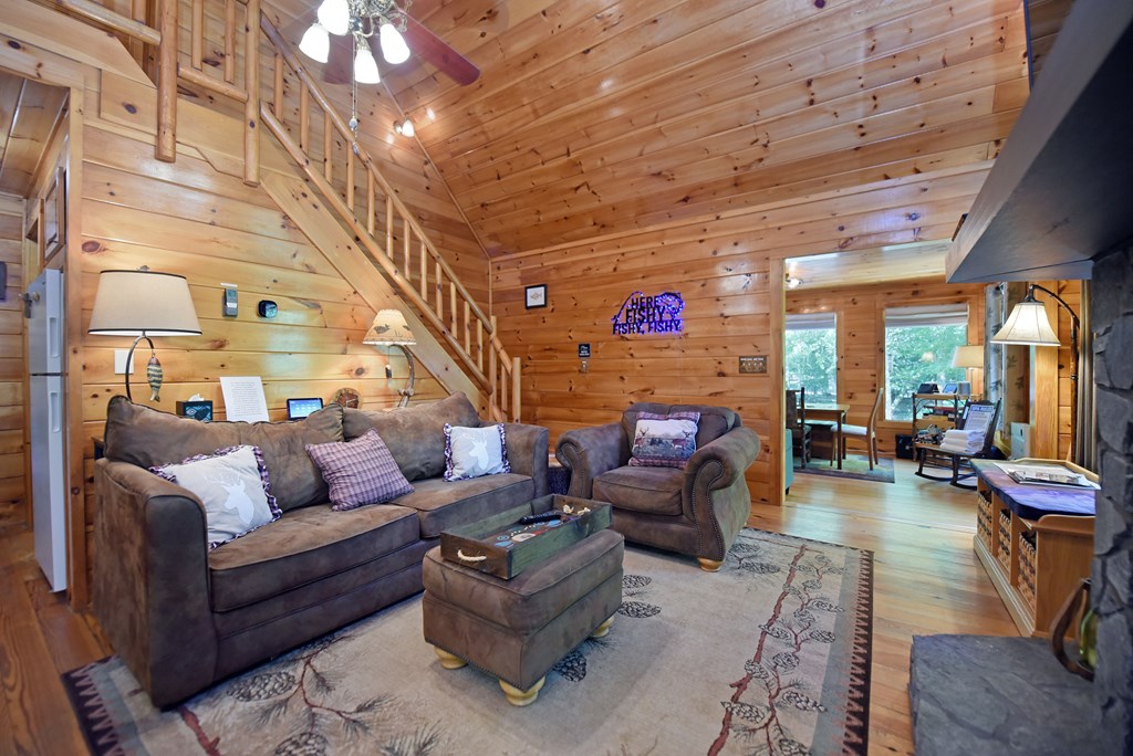 789 Old Mill Pond Road Mineral Bluff, GA 30559 - Photo 23 of 59 a living room with furniture and a fireplace