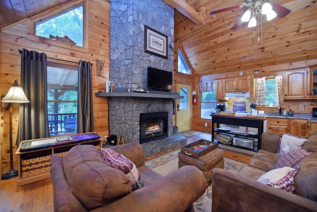 789 Old Mill Pond Road Mineral Bluff, GA 30559 - Photo 25 of 59 a living room with furniture and a fireplace