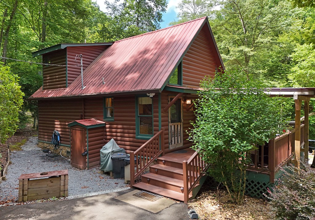 789 Old Mill Pond Road Mineral Bluff, GA 30559 - Photo 3 of 59 a front view of a house with a garden