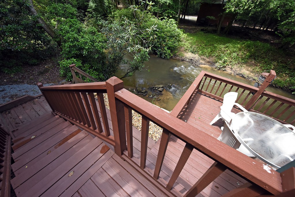 789 Old Mill Pond Road Mineral Bluff, GA 30559 - Photo 36 of 59 a balcony with wooden floor and outdoor seating