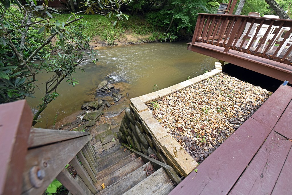 789 Old Mill Pond Road Mineral Bluff, GA 30559 - Photo 37 of 59 a wooden bench sitting in the middle of a lake