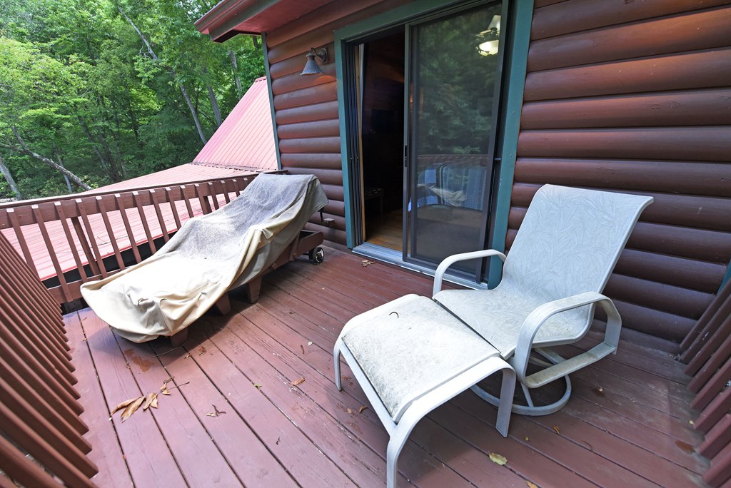 789 Old Mill Pond Road Mineral Bluff, GA 30559 - Photo 43 of 59 a view of a balcony with two chairs and a wooden floor
