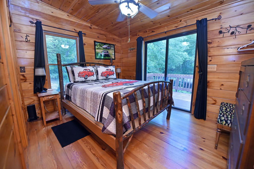 789 Old Mill Pond Road Mineral Bluff, GA 30559 - Photo 52 of 59 a bedroom with a bed and wooden floor
