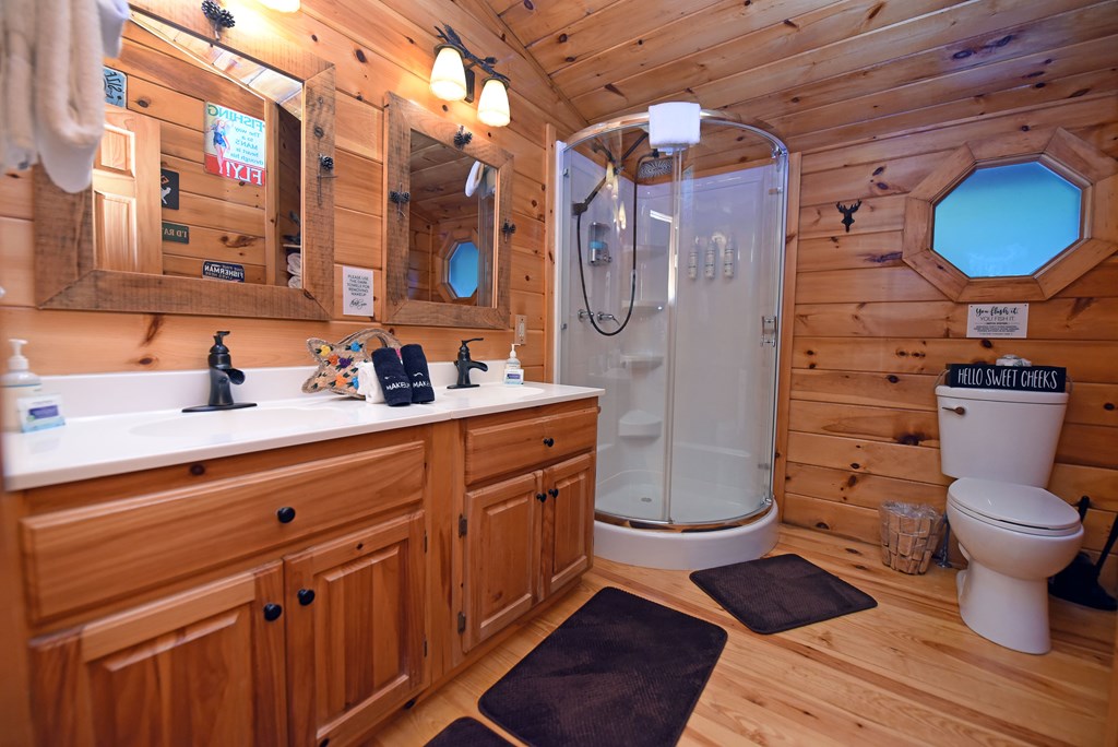 789 Old Mill Pond Road Mineral Bluff, GA 30559 - Photo 54 of 59 a bathroom with a granite countertop toilet sink and mirror