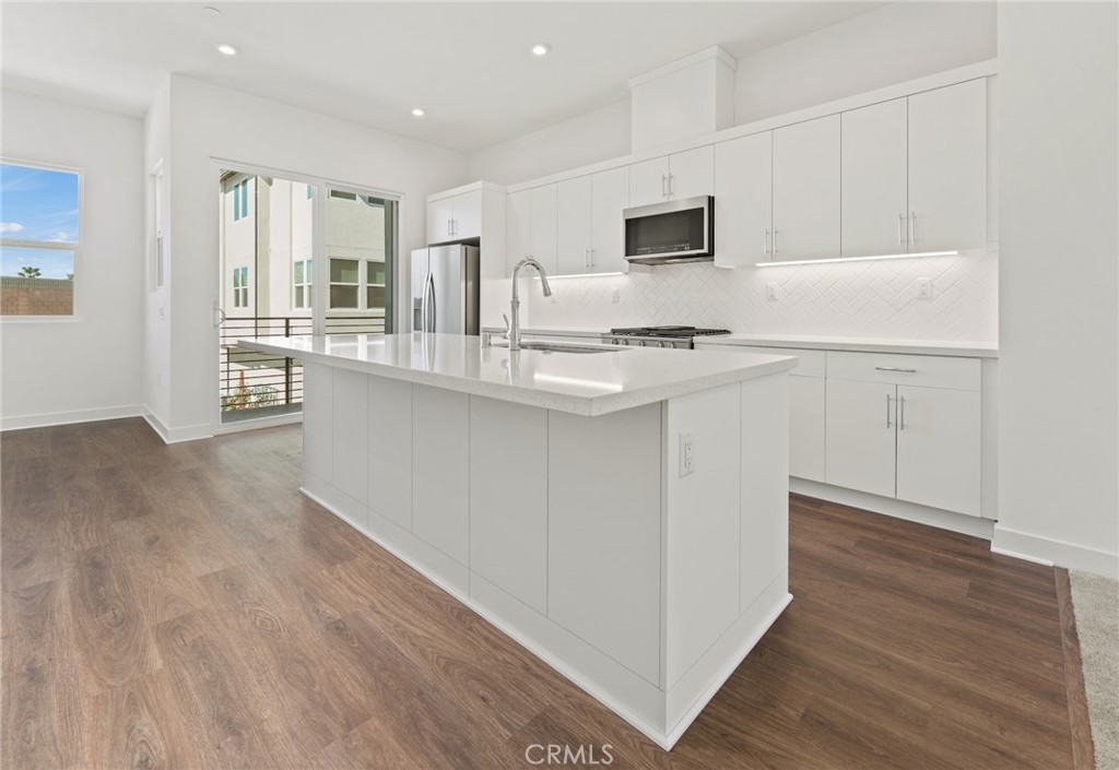 1822 West Bushell Street Anaheim, CA 92805 - Photo 12 of 34 a kitchen with stainless steel appliances granite countertop a sink stove and refrigerator