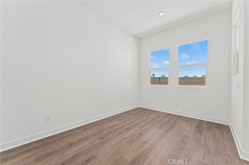 1822 West Bushell Street Anaheim, CA 92805 - Photo 14 of 34 a view of an empty room with wooden floor and a window