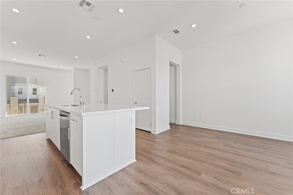 1822 West Bushell Street Anaheim, CA 92805 - Photo 15 of 34 a kitchen with cabinets and wooden floor