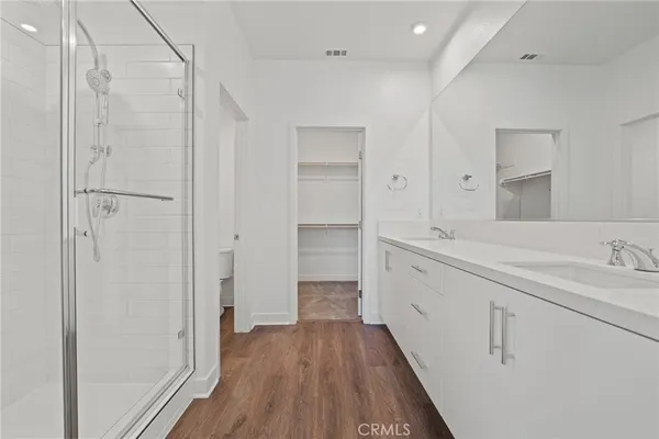 a bathroom with a double vanity sink and mirror