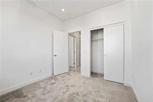 a bathroom with a toilet sink vanity and mirror