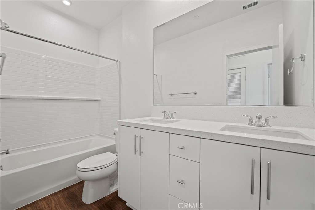 1822 West Bushell Street Anaheim, CA 92805 - Photo 30 of 34 a bathroom with a toilet sink vanity and mirror