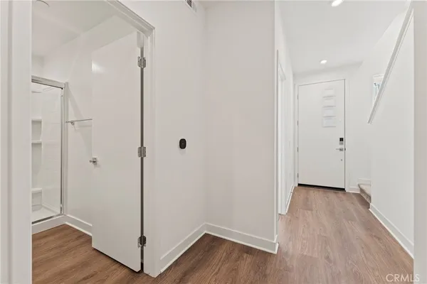 a view of a hallway with wooden floor