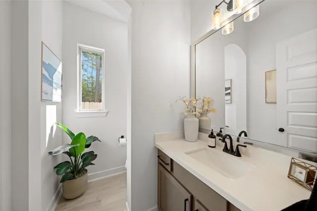 a bathroom with a sink vanity and a mirror