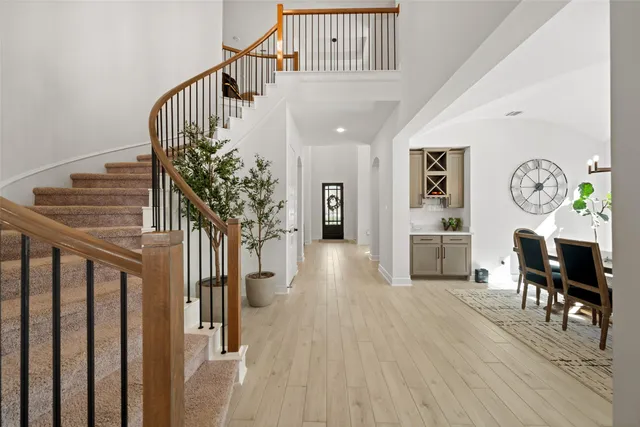 a view of entryway and hall with wooden floor
