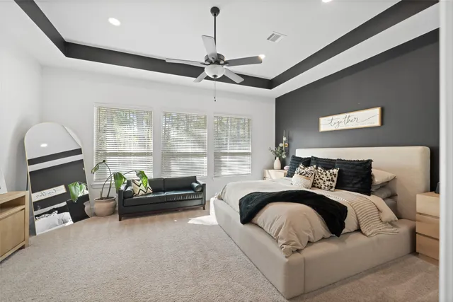 a bedroom with furniture and a flat screen tv