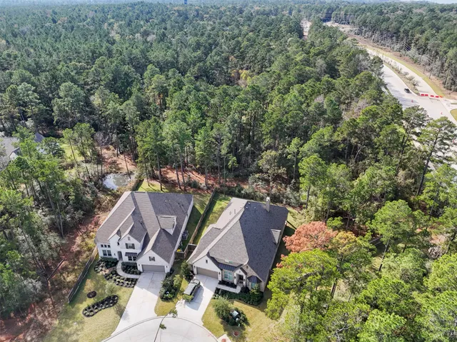 an aerial view of a house with yard and outdoor seating
