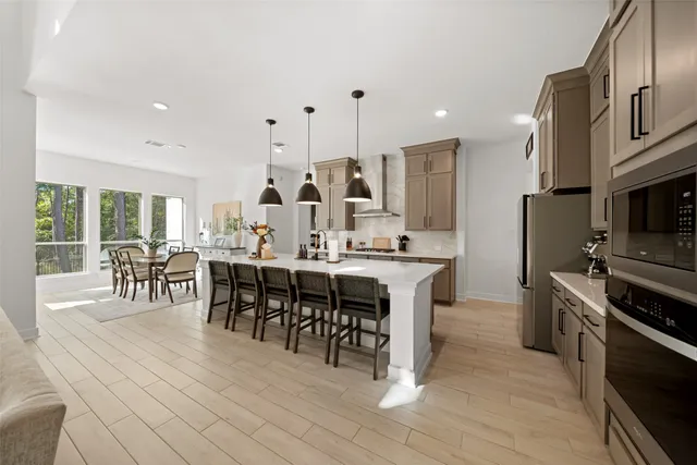a large kitchen with a table and chairs