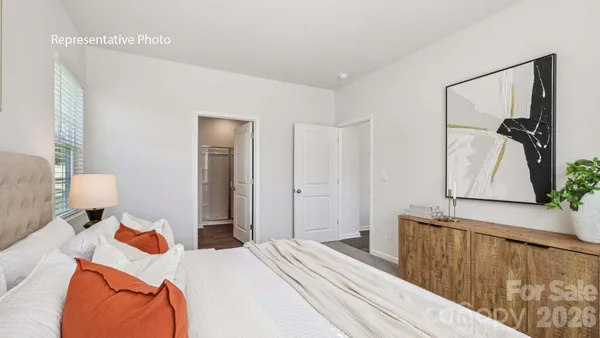a bedroom with bed and wooden floor