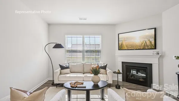 a living room with furniture a window and a fireplace
