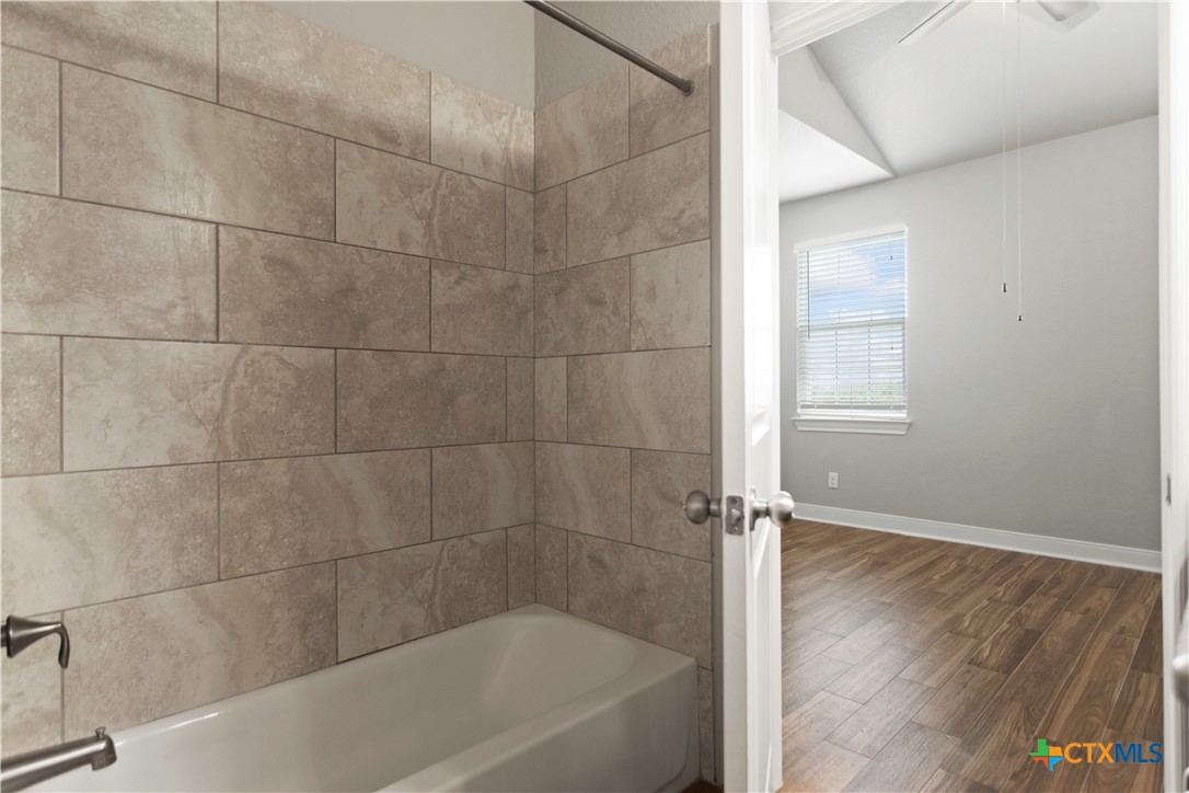 3067 View Ridge Drive, Unit 15 Spring Branch, TX 78070 - Photo 8 of 15 a bath tub sitting next to a window